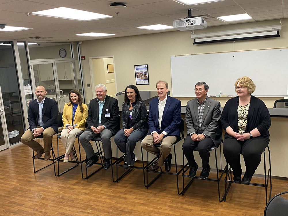 a group of professionals at a press conference