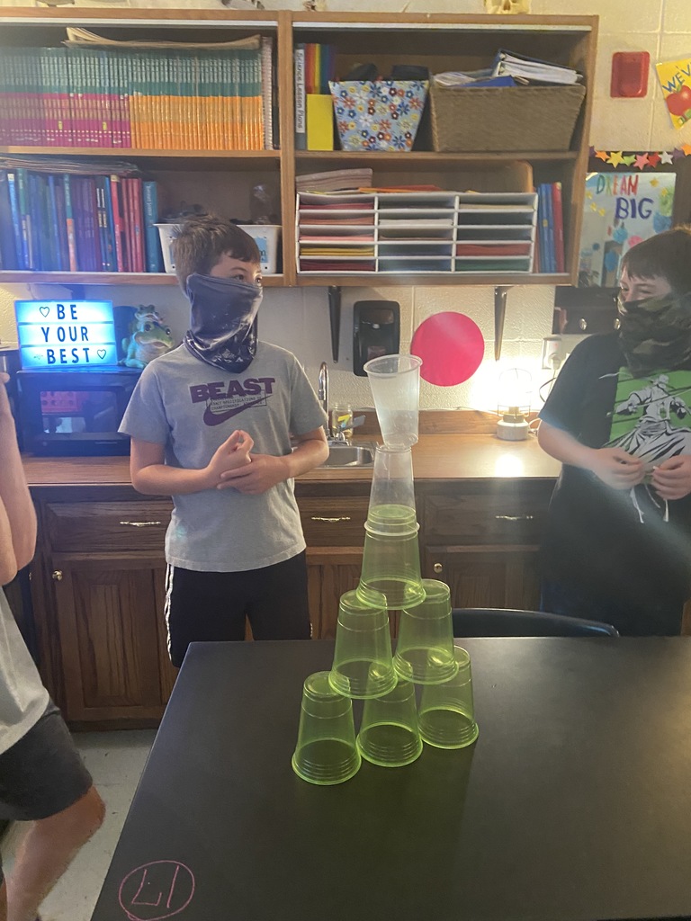 sixth grade student stacking plastic cups to build towers