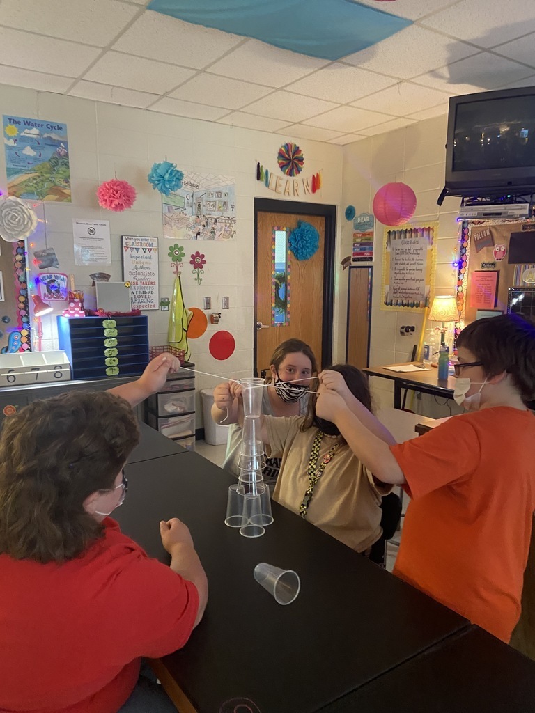sixth grade student stacking plastic cups to build towers