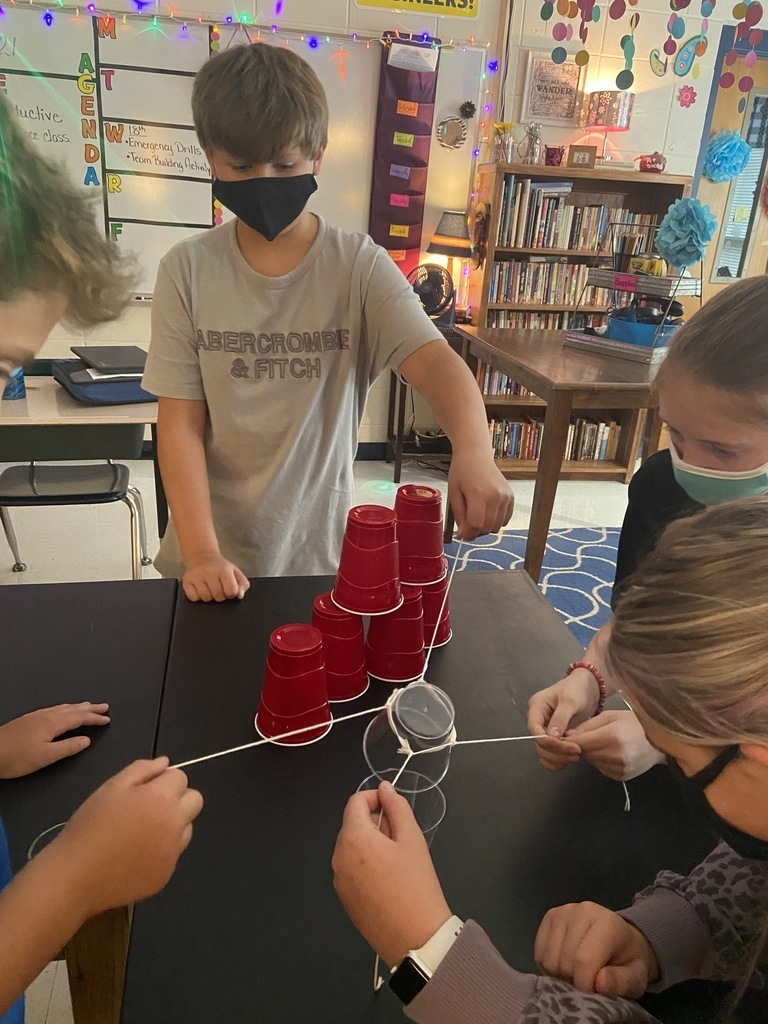 sixth grade student stacking plastic cups to build towers