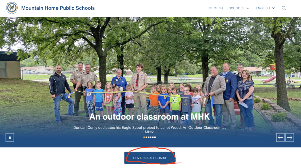 a screenshot of the website homepage with the COVID-19 Dashboard button circled