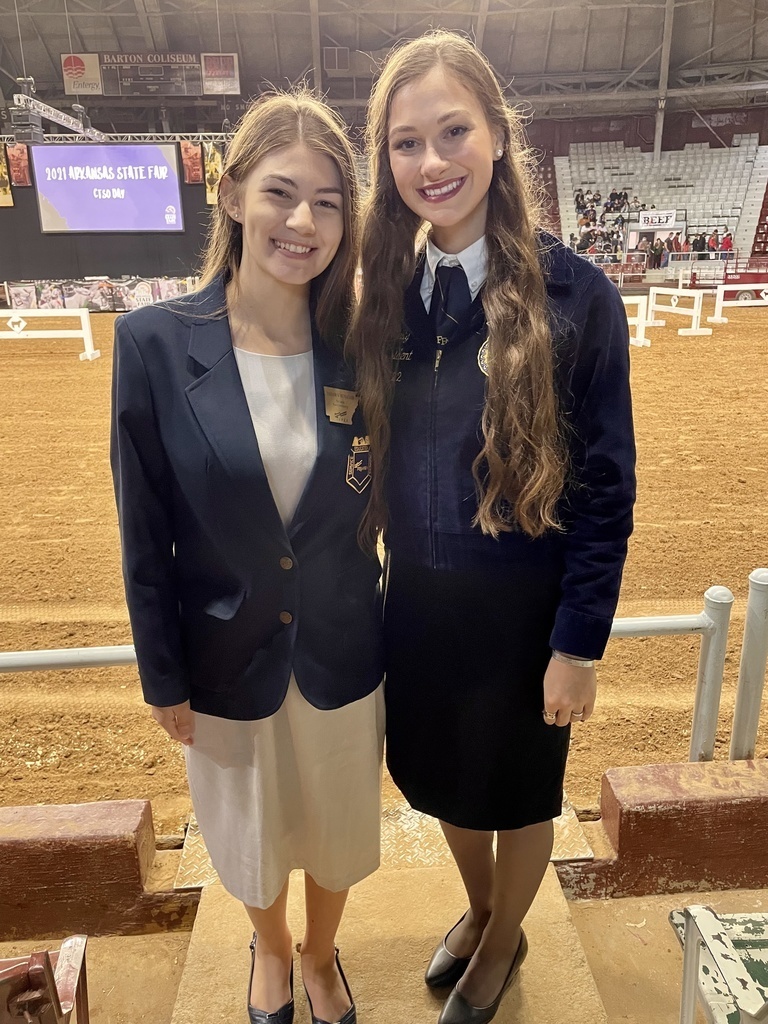 two teen girls in a rodeo arena