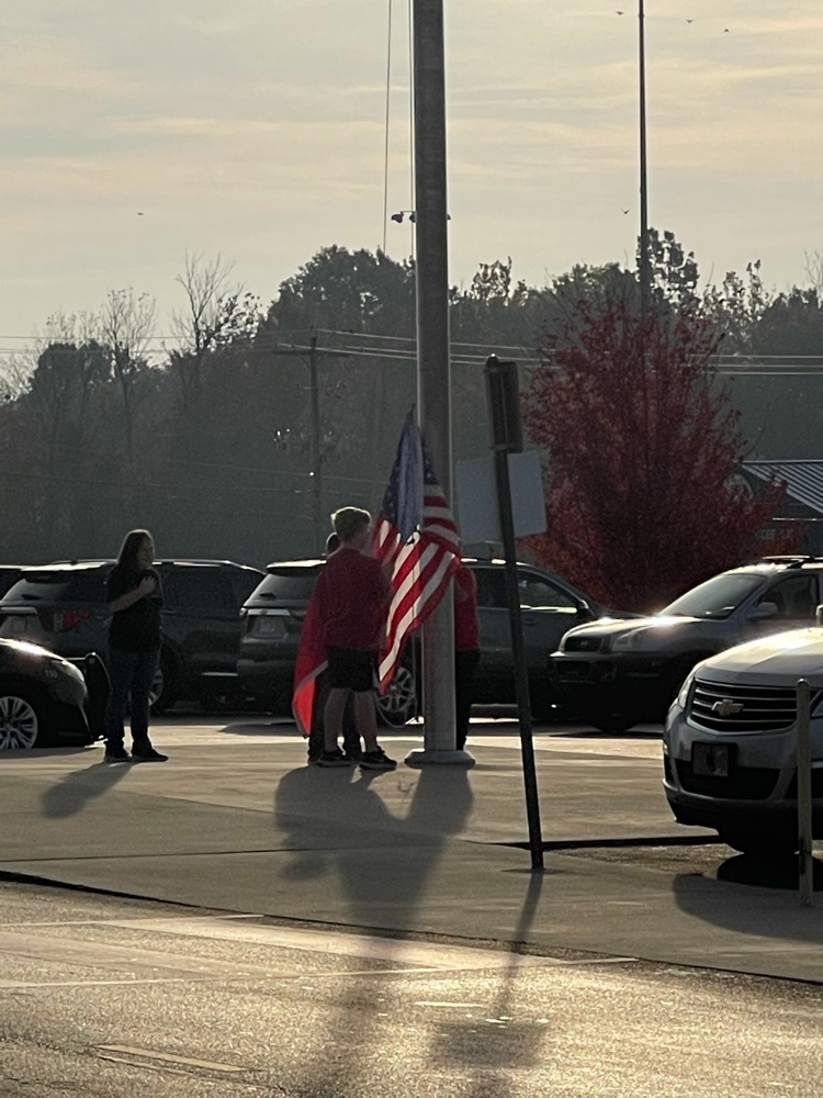 students raising flag