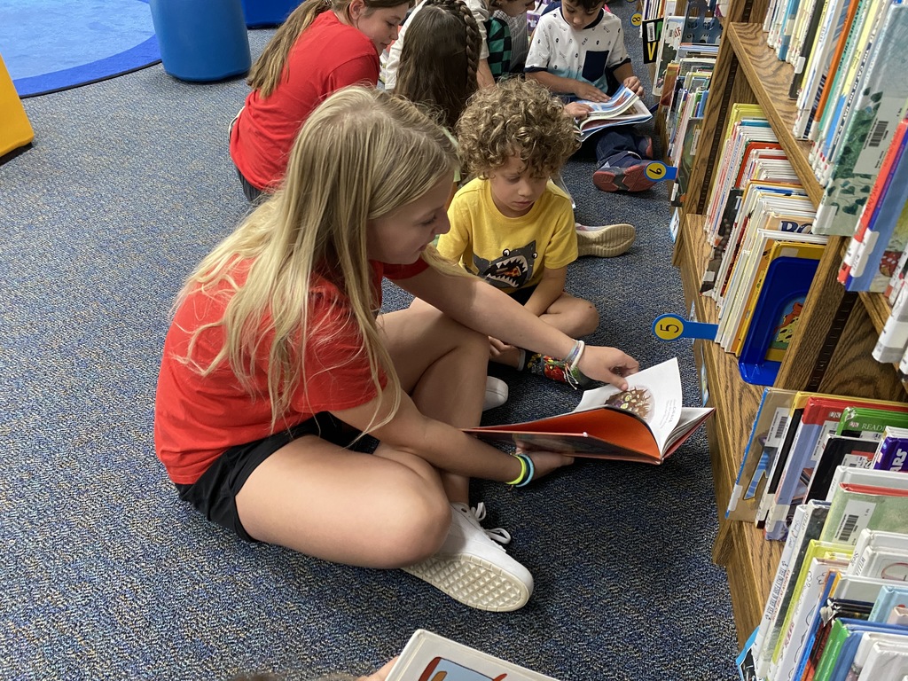 6th graders and kinders in the library