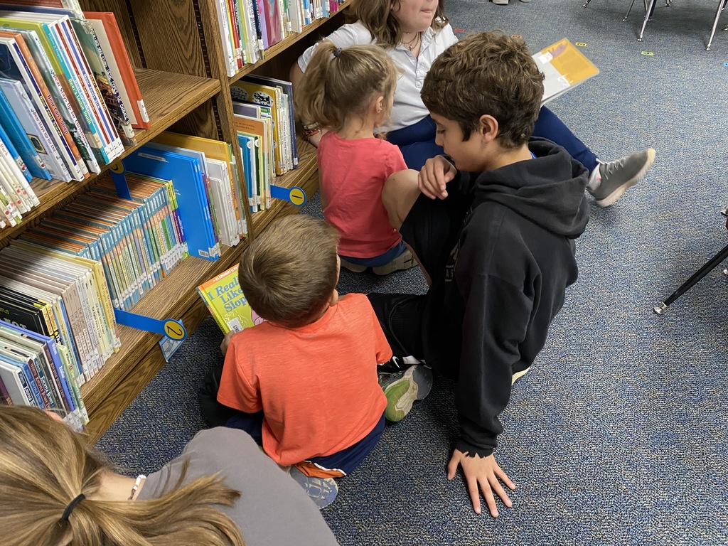 6th graders and kinders in the library