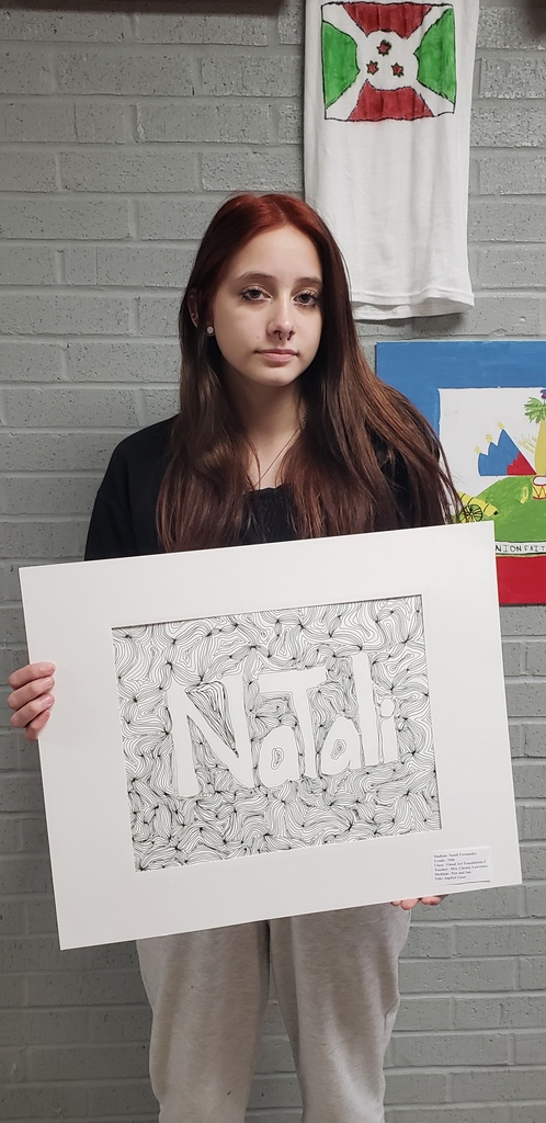 a high school girl holding her art project