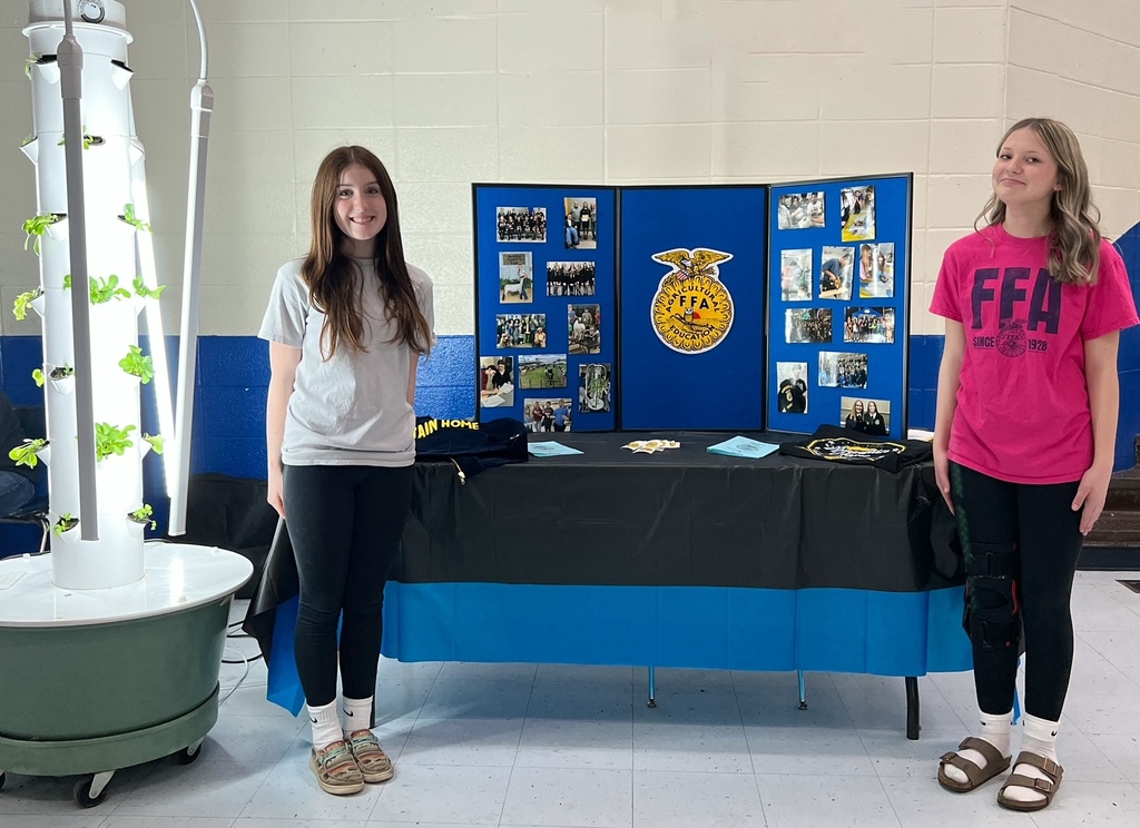 two girls with a presentation board about FFA
