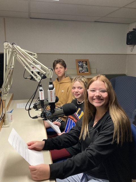 three kids in a recording booth at radio station